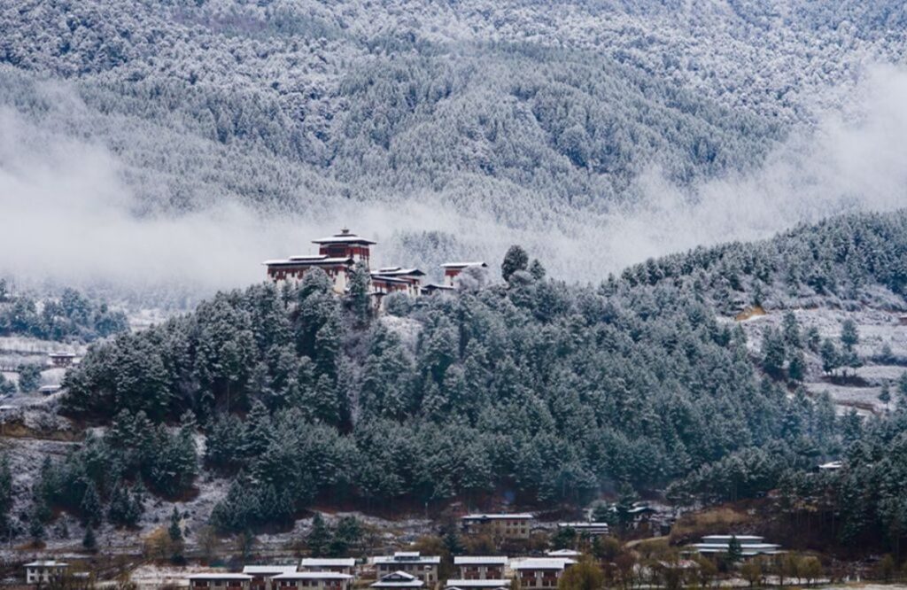 A monastery above the Bumthang valley in winter mist and light snow