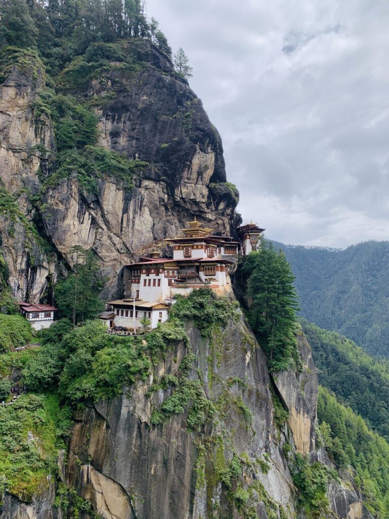 The Tiger's Nest below the overhanging rock face, reached by the path through the pines