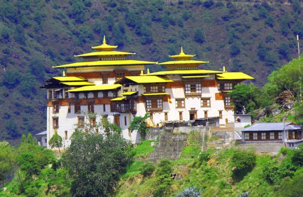 Trashigang Dzong with its golden roofs above dense forest in eastern Bhutan