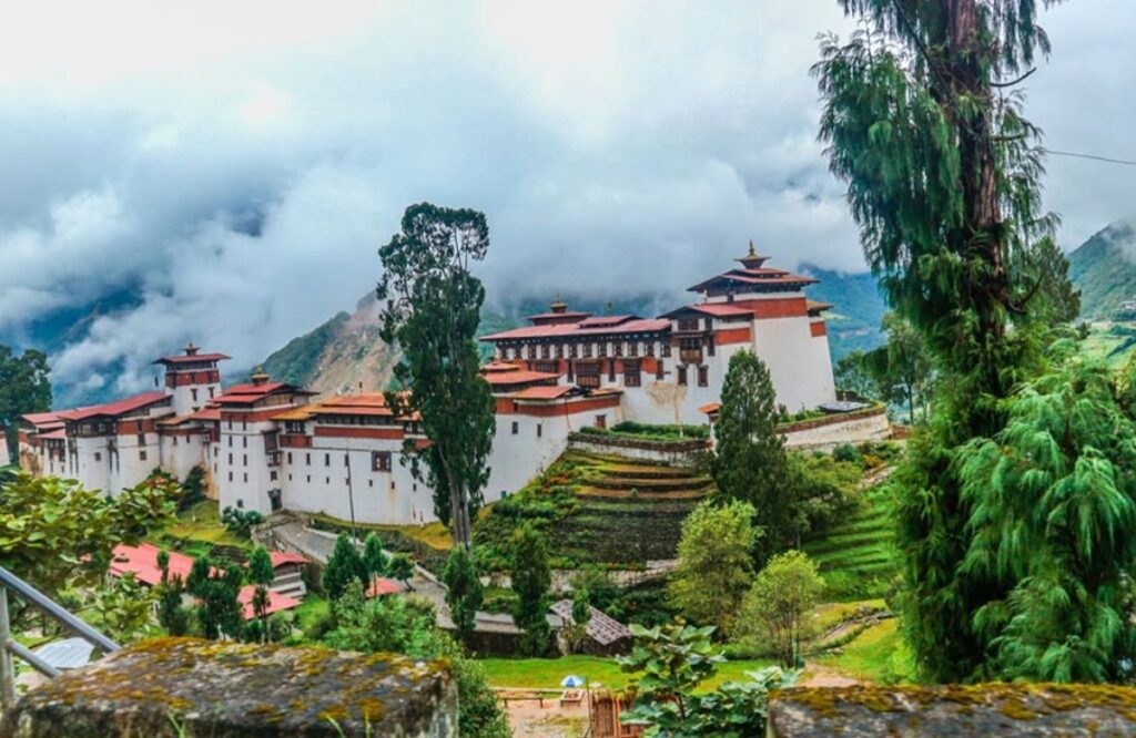 Trongsa Dzong and its terraces emerging from mist on the ridge
